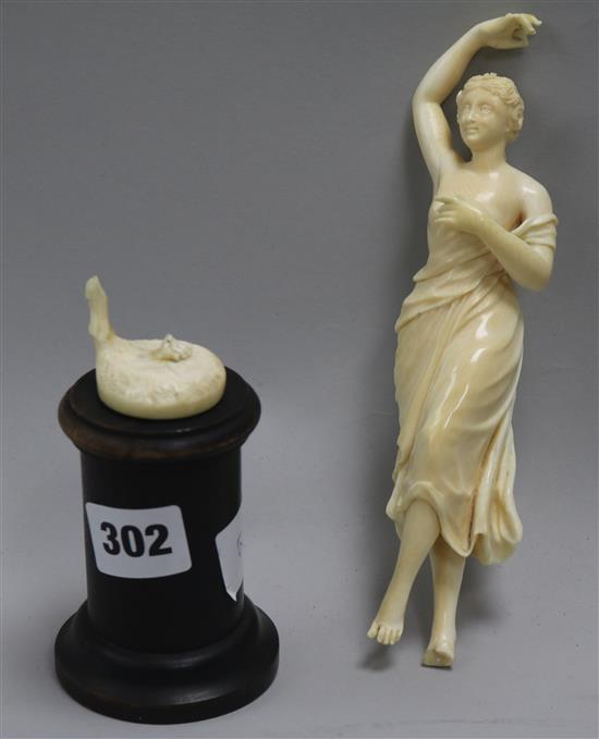 A carved ivory figurine on stand